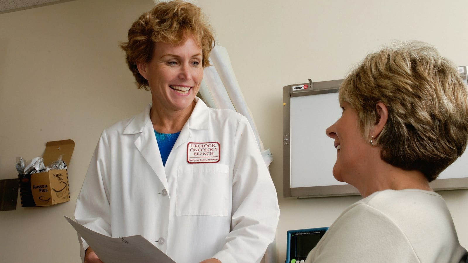 Smiling doctor talking with a patient
